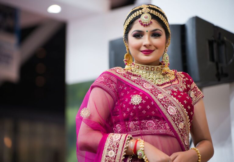A beautiful woman elegantly dressed in a traditional Indian saree with intricate jewelry, showcasing cultural fashion.
